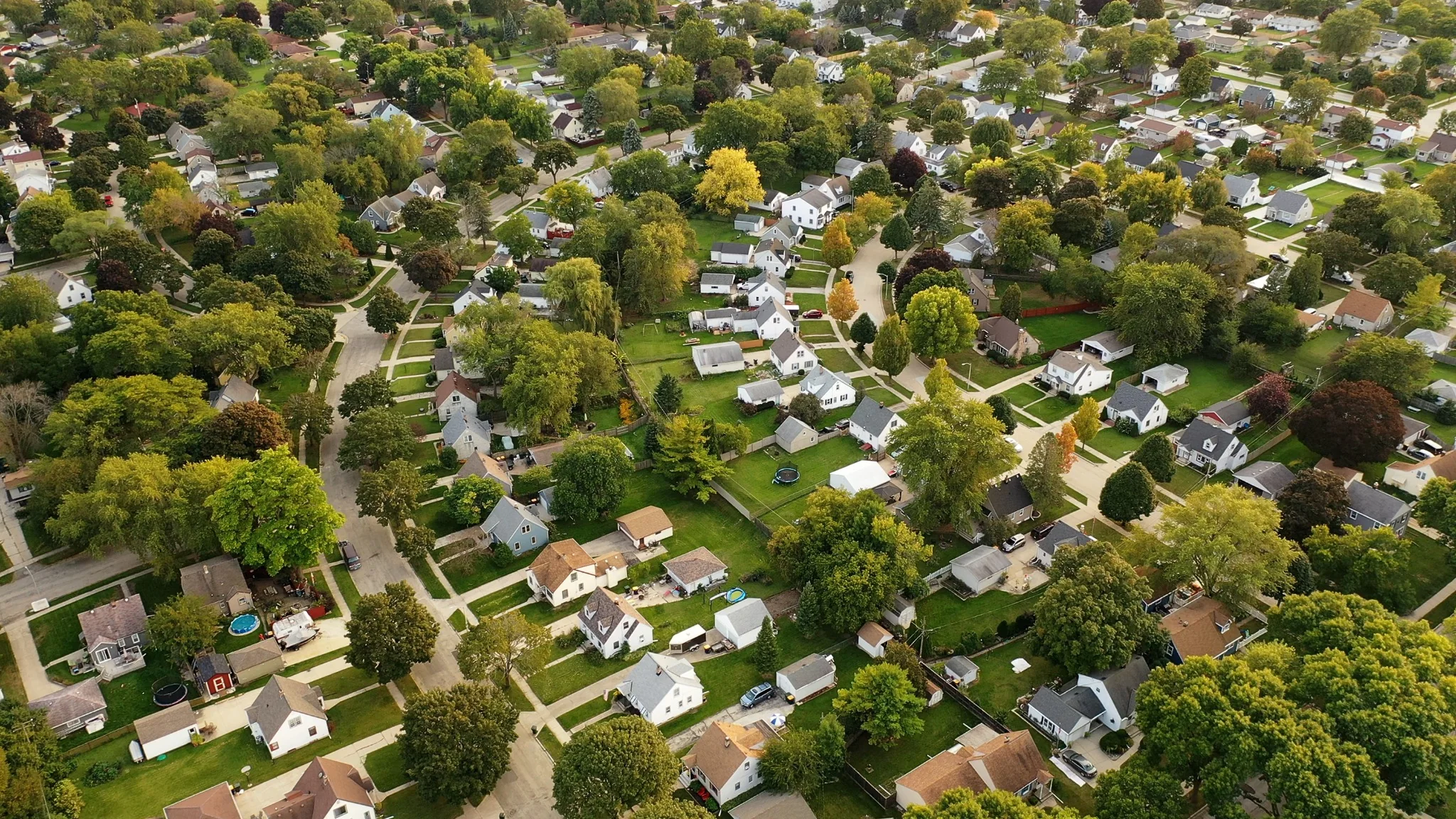 Aerial view of a residential neighborhood in a green valley