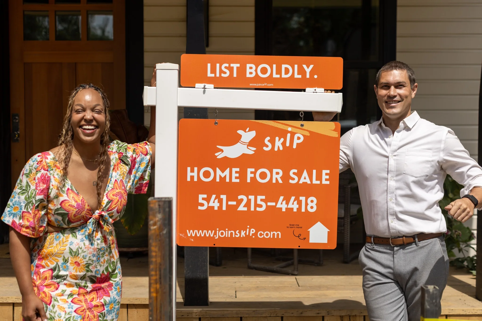 Skip Real Estate agents beside a home-for-sale sign